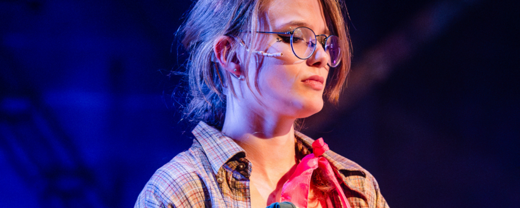 Mickey (Alfi Free) standing solemnly thinking about the sailor hat that belinged to their grandfather in Connecticut Rep's production of The Old Man and The Old Moon.