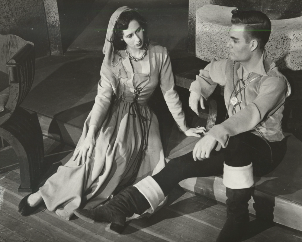 In one of CRT's productions from 1955, a man and a woman look longingly at each other while sitting on the floor in a scene from The Lady's Not for Burning.