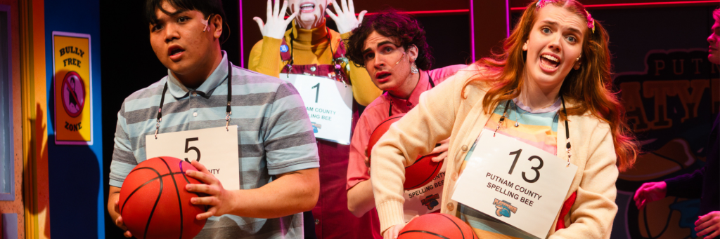 In a scene from The 23rd Annual Putnam County Spelling Bee, a group of youngsters sing while holding basketballs.