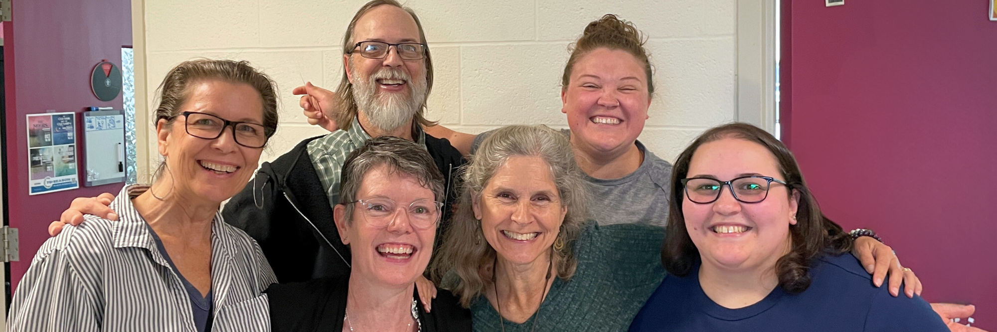Connecticut Rep's production team smiling while embracing one another as a group.